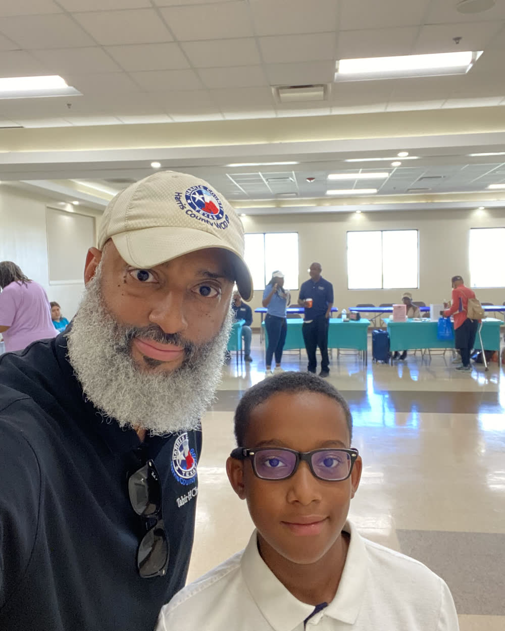 Tahir Charles with a young student in the district community room during an event.